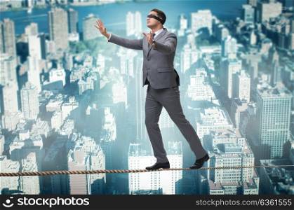 Man walking in tight rope blindfold