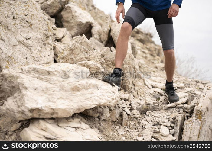 man walking through rocks nature