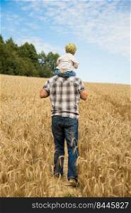 man walking with his kid in the field