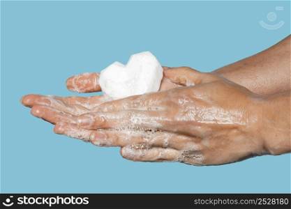 man washing hands with heart shaped white soap 2
