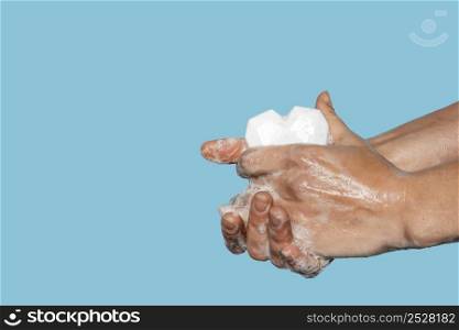 man washing hands with heart shaped white soap