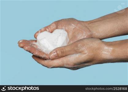 man washing hands with white soap