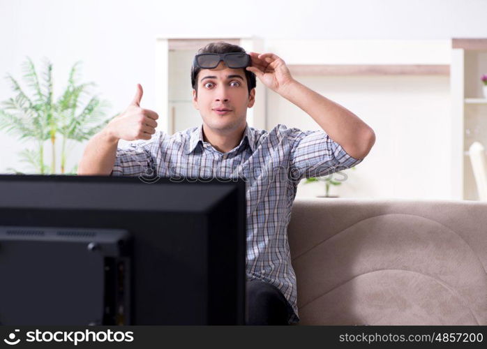 Man watching 3d tv at home