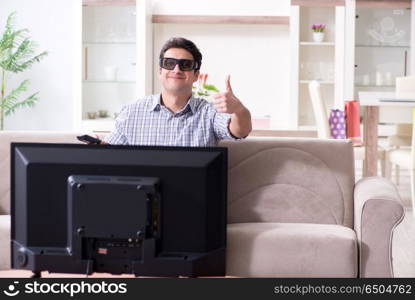 Man watching 3d tv at home