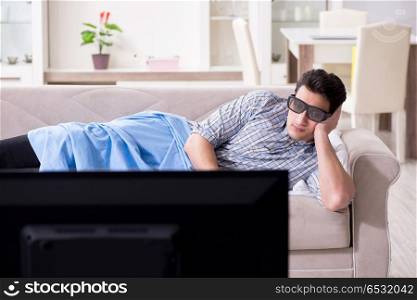 Man watching 3d tv at home