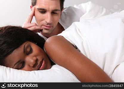 Man watching his girlfriend sleep