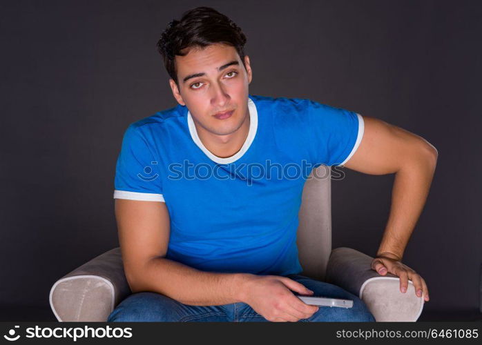 Man watching sports on gray background