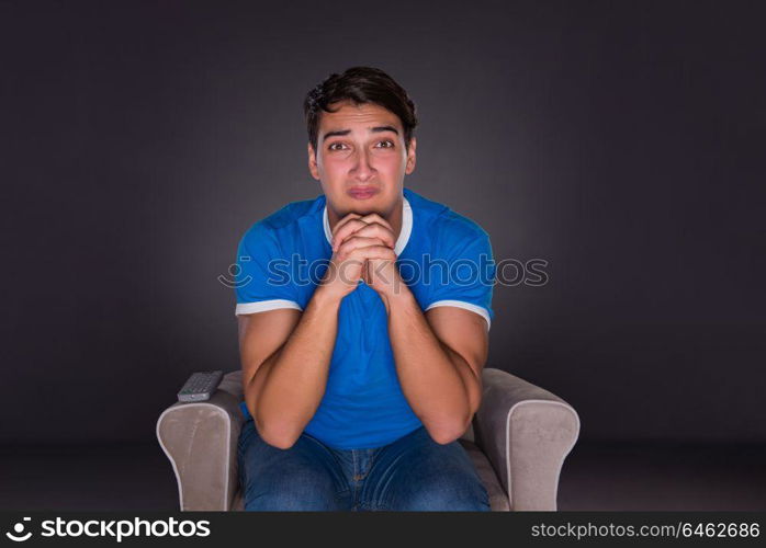 Man watching sports on gray background