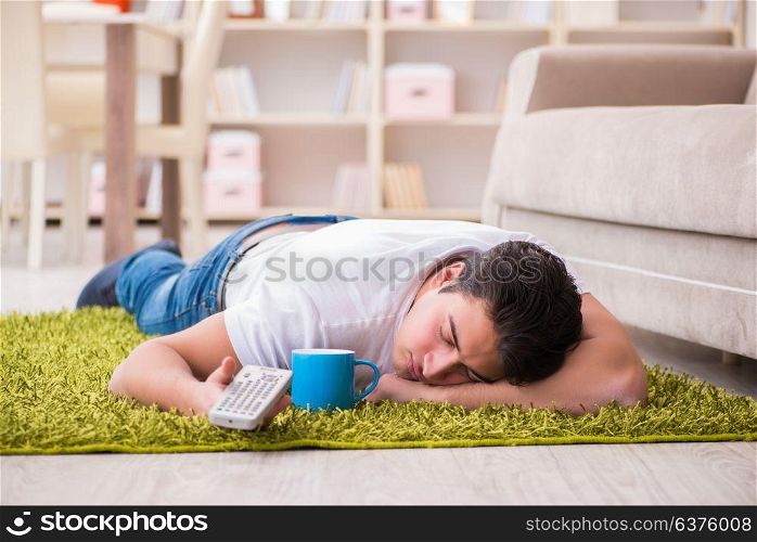 Man watching tv at home on floor