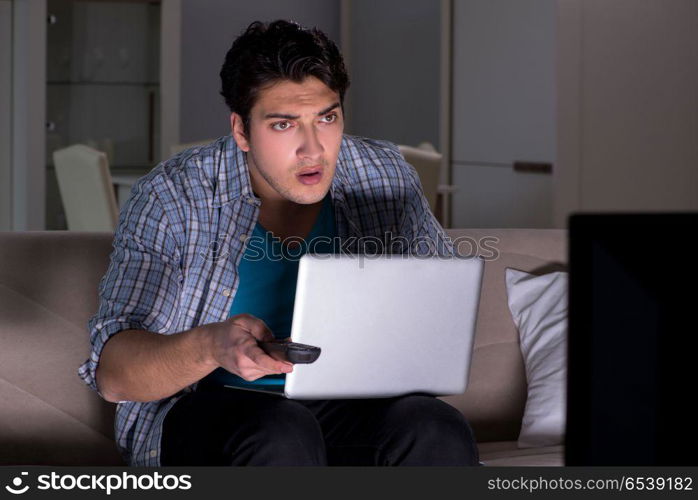 Man watching tv late at night