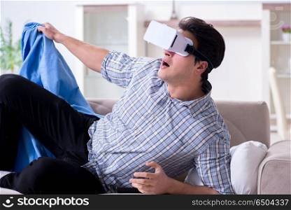 Man watching virtual reality glasses at home