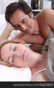 Man watching woman sleeping