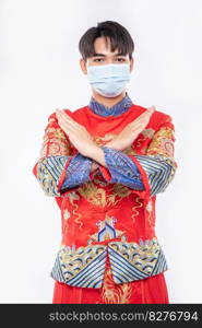 Man wear Cheongsam suit and mask show people don’t wear mask can not be come to shop in chinese new year