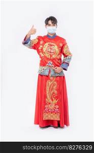 Man wear Cheongsam suit and mask show the best way to shopping for protecting disease