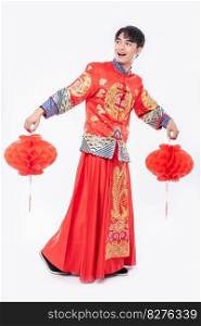 Man wear Cheongsam suit show decorate red l&to his shop in chinese new year 