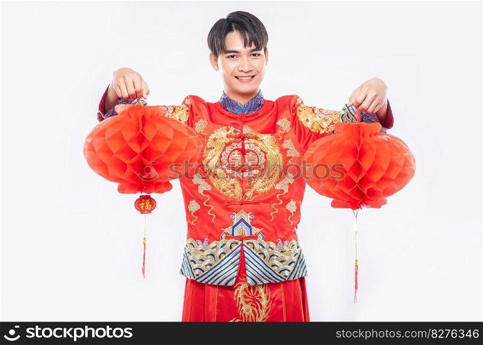Man wear Cheongsam suit show decorate red l&to his shop in chinese new year 