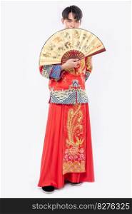 Man wear Cheongsam suit show the chinese hand fan on big event in chinese new year 