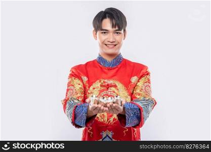 Man wear Cheongsam suit smile and standing to give the gift money to his family