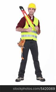 Man wearing a hard hat and holding large clippers