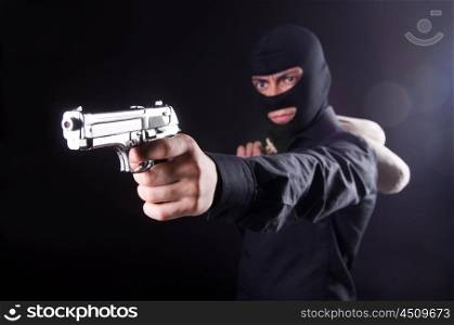 Man wearing balaclava with gun