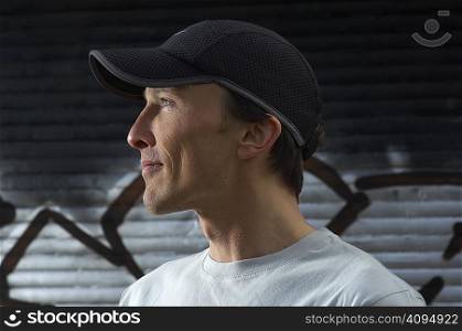 Man wearing cap smiling side view