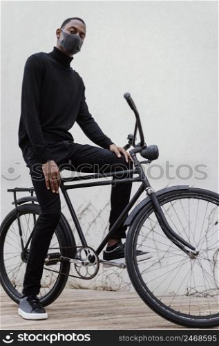man wearing facial mask riding his bike 2