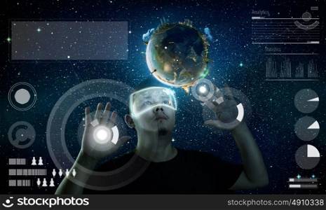 Man wearing futuristic virtual reality glasses . Elements of this image furnished by NASA.