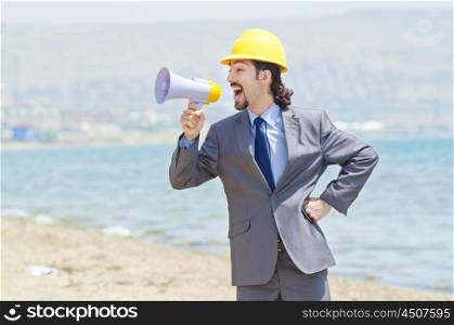 Man wearing helmet speaks with megaphone