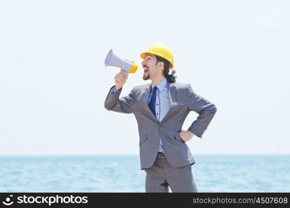 Man wearing helmet speaks with megaphone