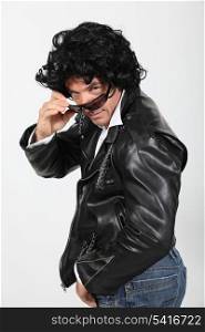 Man wearing leather jacket, sunglasses and wig