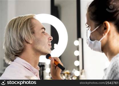 man wearing make up beauty salon side view