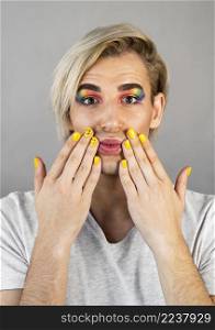 man wearing make up cosmetics nail polish