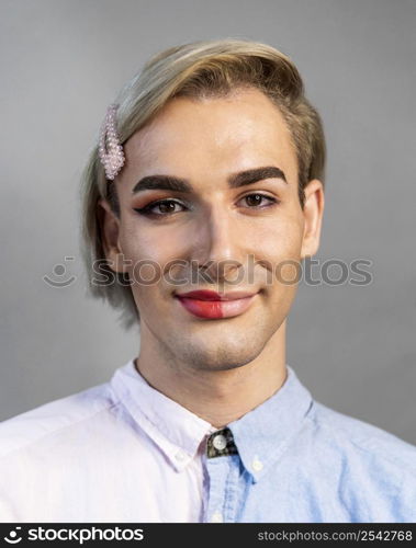 man wearing make up half his face smiles