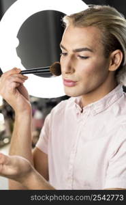 man wearing make up looking down