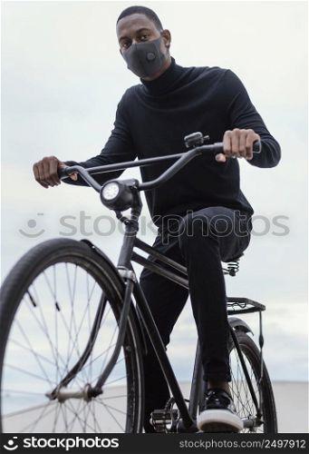 man wearing mask riding his bike city 2