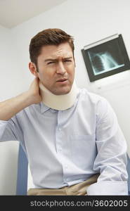 Man wearing neck brace in hospital