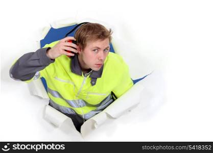 Man wearing reflective jacket and hearing protection