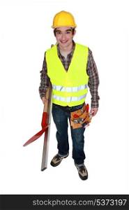 Man wearing reflective jacket and holding spade