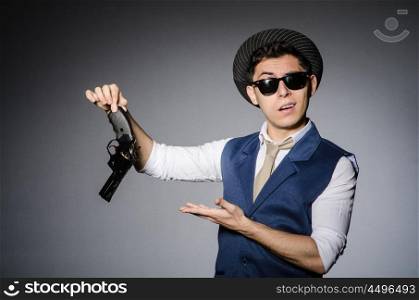 Man wearing sunglasses with gun