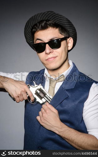 Man wearing sunglasses with gun