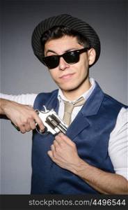 Man wearing sunglasses with gun