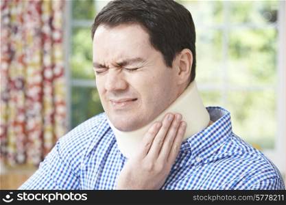 Man Wearing Surgical Collar In Pain