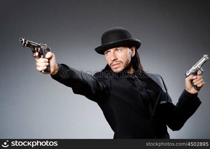 Man wearing vintage hat with gun