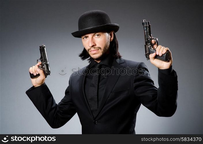 Man wearing vintage hat with gun