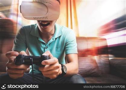 Man wearing virtual reality goggles watching movies or playing video games. The vr headset design is generic and no logos