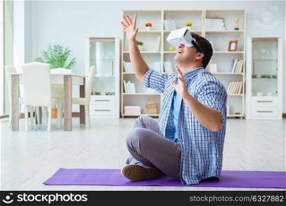 Man wearing virtual reality VR glasses doing sports at home. The man wearing virtual reality vr glasses doing sports at home