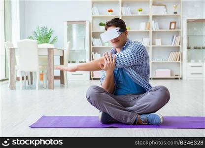 Man wearing virtual reality VR glasses doing sports at home