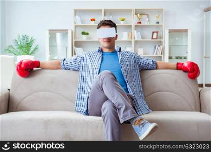Man wearing virtual reality VR glasses playing boxing game