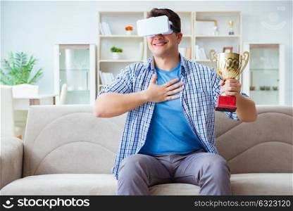 Man wearing virtual reality VR glasses receiving prize cup award