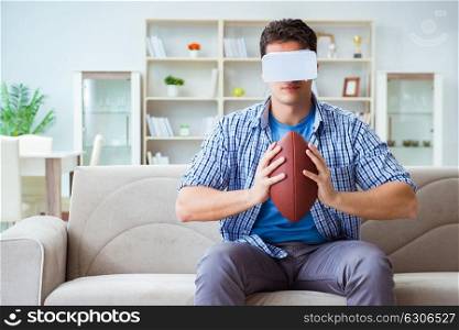 Man wearing virtual reality VR glasses watching american football. Man wearing virtual reality VR glasses watching american footbal